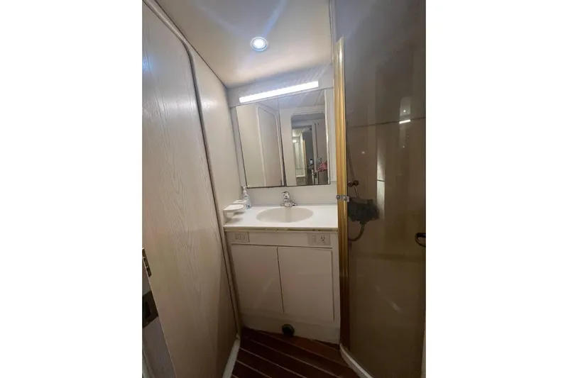 Slide: The Image of 1996 Ocean Yachts 48 Super Sport cabin interior with bed and storage drawers. - 27