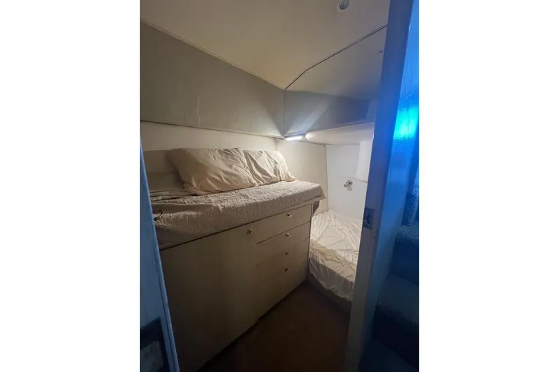 Slide: The Image of Cozy cabin interior of 1996 Ocean Yachts 48 Super Sport with bed and soft lighting. - 28
