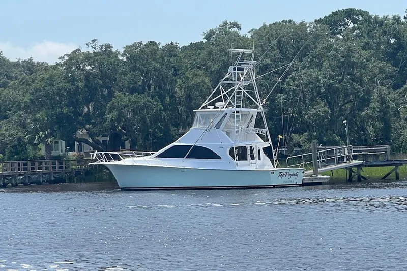 Slide: The Image of 1996 Ocean Yachts 48 Super Sport docked, showcasing sleek design and fishing equipment. - 3