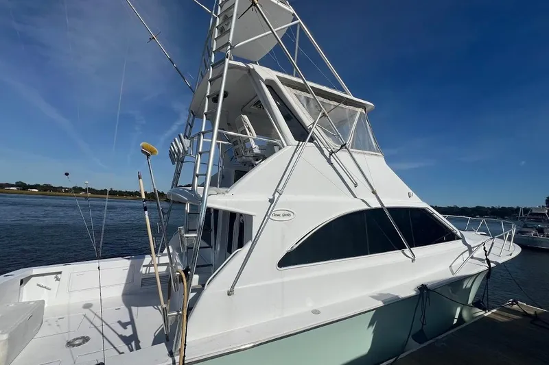 Slide: The Image of 1996 Ocean Yachts 48 Super Sport docked, showcasing sleek design and spacious deck. - 4