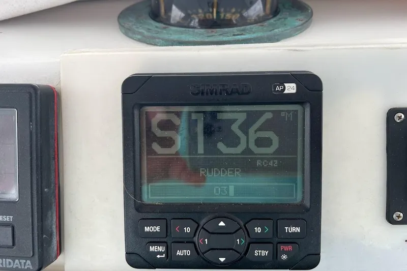 Slide: The Image of Cockpit of 1996 Ocean Yachts 48 Super Sport with steering wheel and navigation controls. - 40