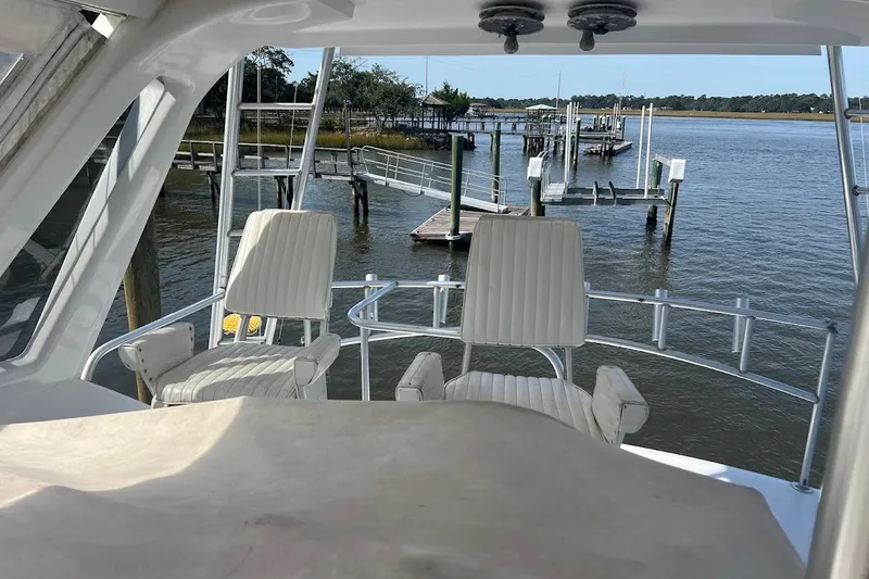 Slide: The Image of Flybridge view of 1996 Ocean Yachts 48 Super Sport, overlooking a serene marina. - 44