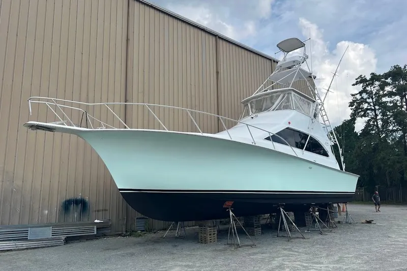 Slide: The Image of 1996 Ocean Yachts 48 Super Sport boat on stands, outdoor storage setting. - 52