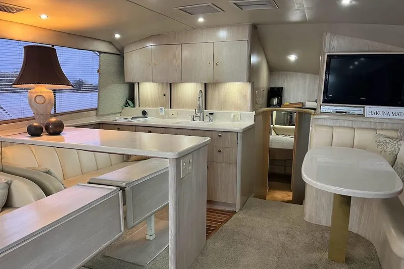 Slide: The Image of Luxurious interior of 1996 Ocean Yachts 48 Super Sport with seating, table, and entertainment system. - 7