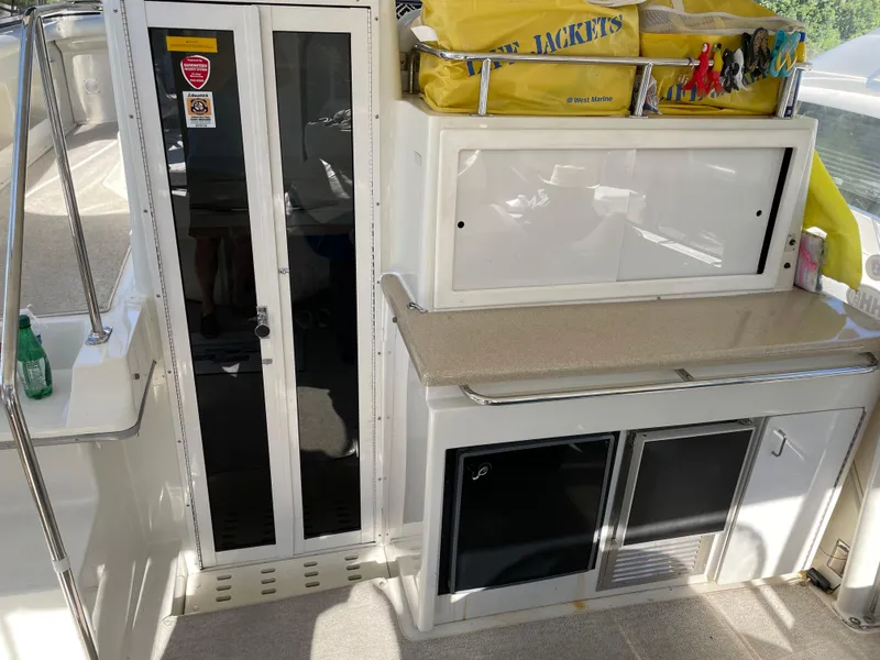 Slide: The Image of 1998 Carver 445 Aft Cabin Motor Yacht interior with kitchenette and storage. - 19