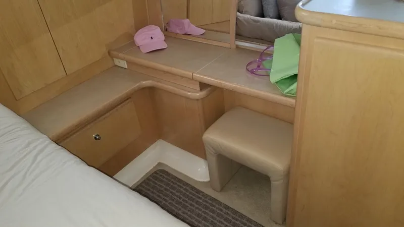 Slide: The Image of 1998 Carver 445 Aft Cabin Motor Yacht interior with vanity and seating area. - 35