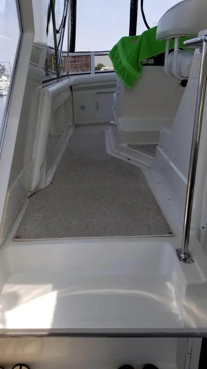 Slide: The Image of 1998 Carver 445 Aft Cabin Motor Yacht interior with carpeted walkway and seating. - 43