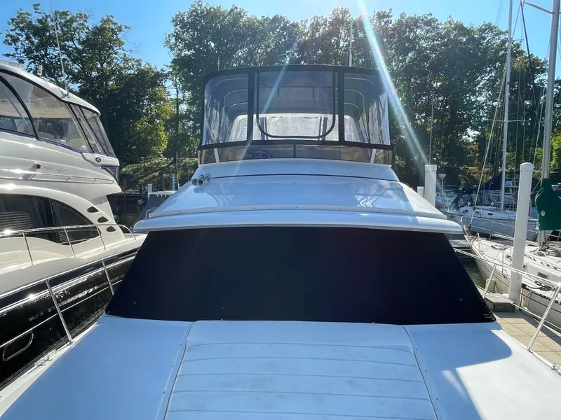 Slide: The Image of 1998 Carver 445 Aft Cabin Motor Yacht docked in marina, sunny day. - 5