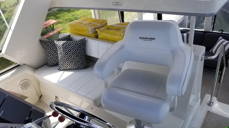 Slide: The Image of Interior of 1998 Carver 445 Aft Cabin Motor Yacht with white seating and patterned cushions. - 9