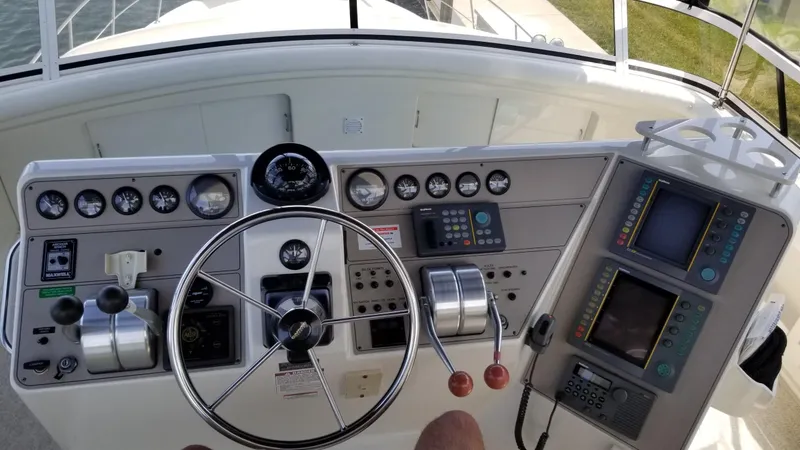 Slide: The Image of Control panel of a 1998 Carver 445 Aft Cabin Motor Yacht with gauges and navigation equipment. - 11