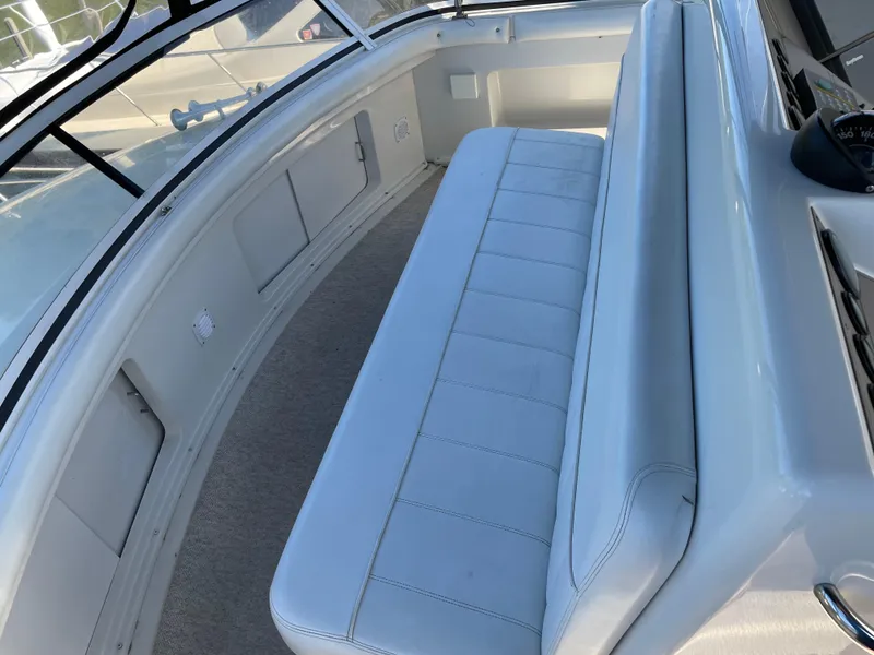 Slide: The Image of 1998 Carver 445 Aft Cabin Motor Yacht interior seating area with white upholstery. - 18