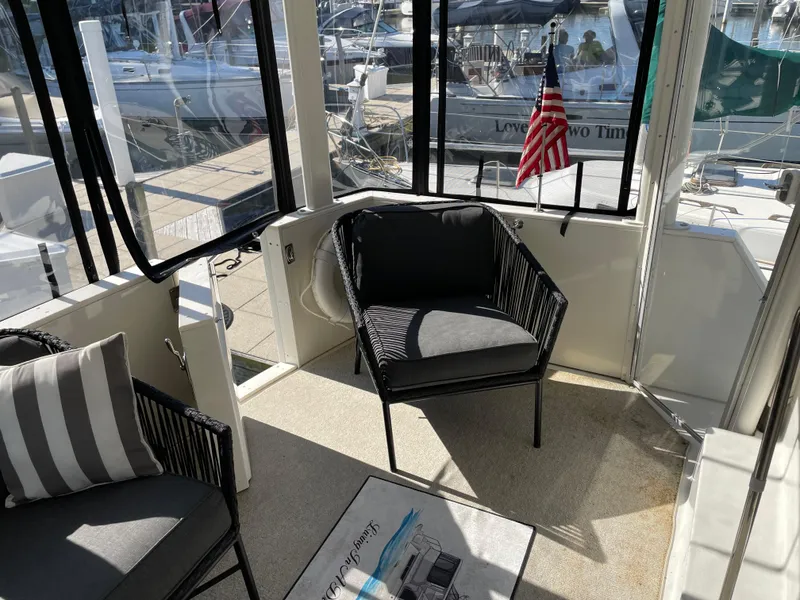 Slide: The Image of 1998 Carver 445 Aft Cabin Motor Yacht interior with seating and American flag. - 20