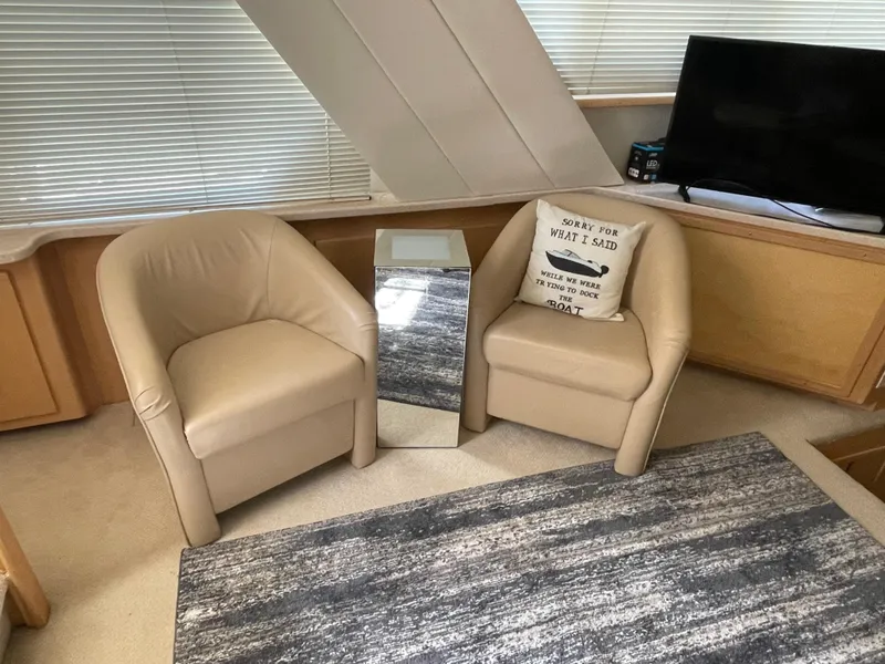 Slide: The Image of Interior of 1998 Carver 445 Aft Cabin Yacht with beige chairs and modern decor. - 24