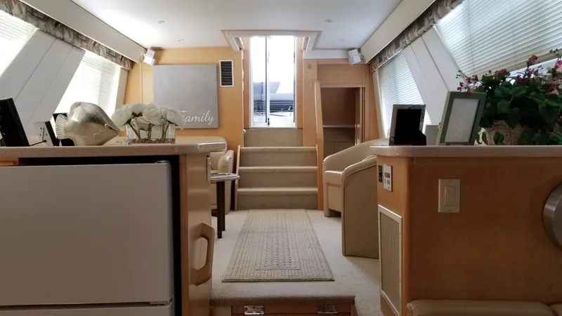 Slide: The Image of Interior of 1998 Carver 445 Aft Cabin Motor Yacht, featuring elegant furnishings and natural light. - 32