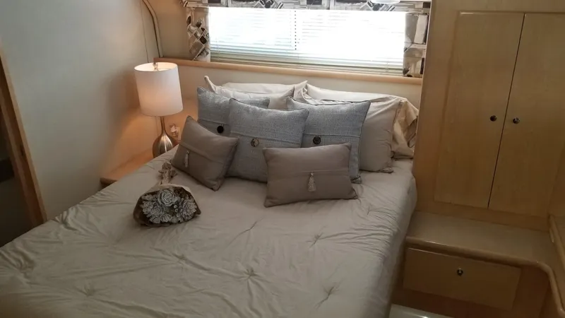 Slide: The Image of Cozy bedroom in 1998 Carver 445 Aft Cabin Motor Yacht with plush pillows and soft lighting. - 33