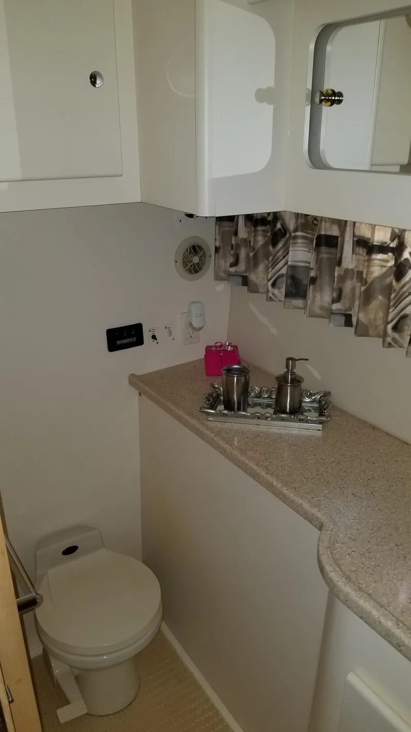 Slide: The Image of 1998 Carver 445 Aft Cabin Motor Yacht bathroom with modern fixtures and storage. - 41