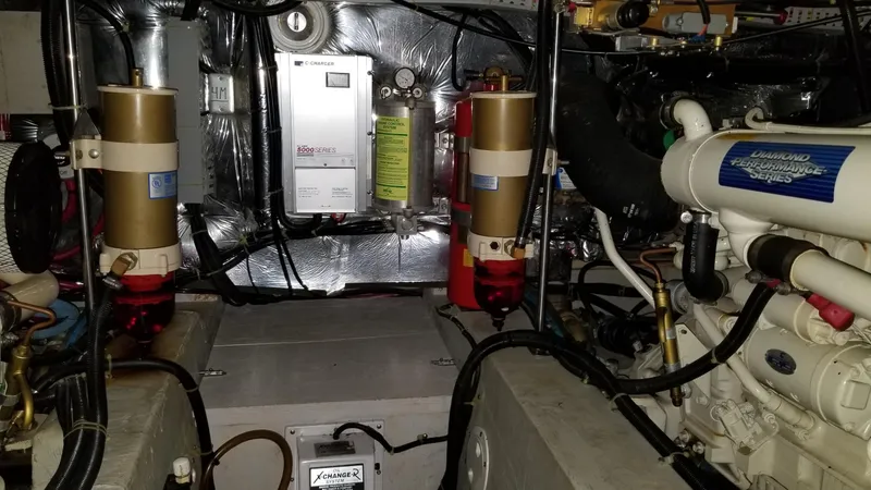 Slide: The Image of Engine room of 1998 Carver 445 Aft Cabin Motor Yacht with mechanical components. - 46