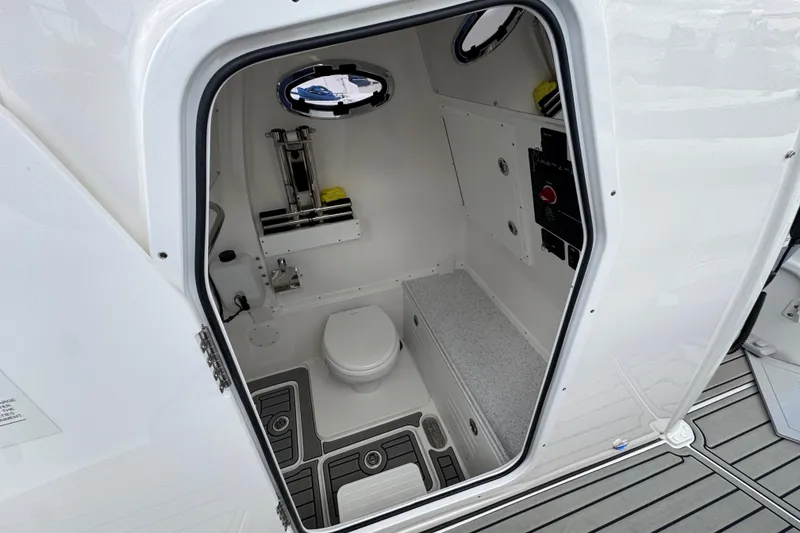 Slide: The Image of 2025 Tidewater 302 CC Adventure boat interior with compact bathroom and modern amenities. - 101