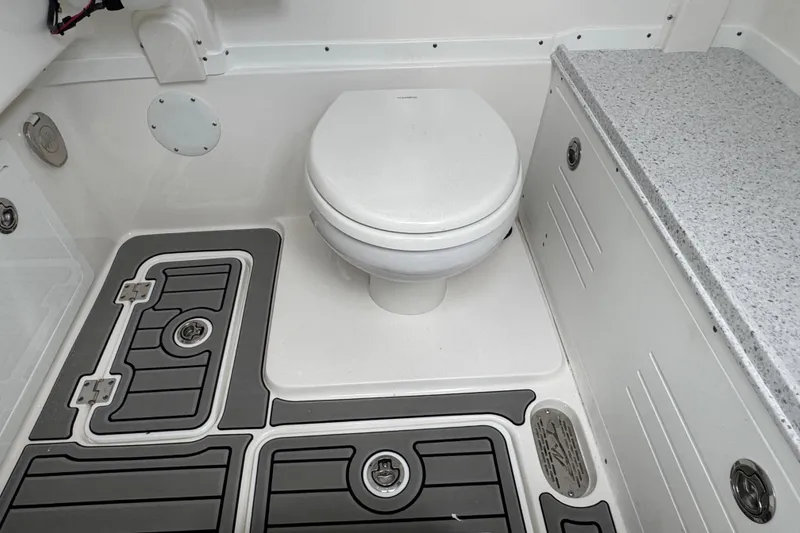 Slide: The Image of 2025 Tidewater 302 CC Adventure boat interior with toilet and non-slip flooring. - 105