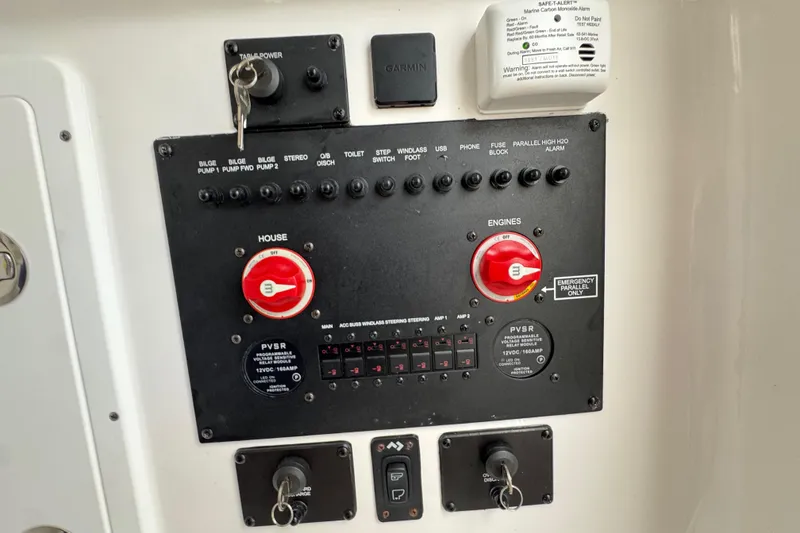 Slide: The Image of Control panel of 2025 Tidewater 302 CC Adventure boat with switches and keys. - 108