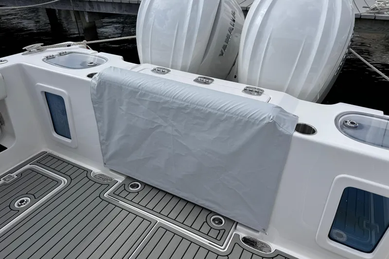 Slide: The Image of 2025 Tidewater 302 CC Adventure boat deck with covered seating and twin Yamaha engines. - 113