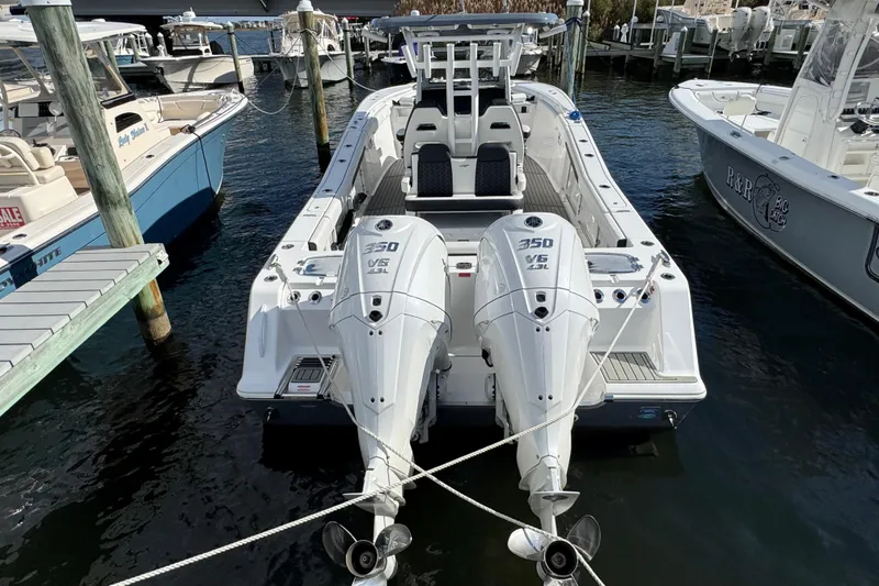 Slide: The Image of 2025 Tidewater 302 CC Adventure boat docked with twin 350 V6 engines. - 19