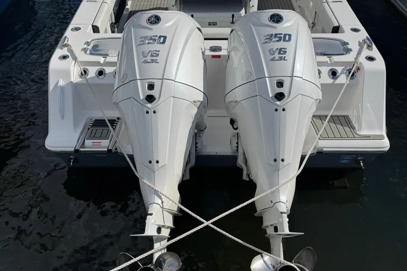Slide: The Image of 2025 Tidewater 302 CC Adventure with dual 350 V6 outboard engines, docked on water. - 20