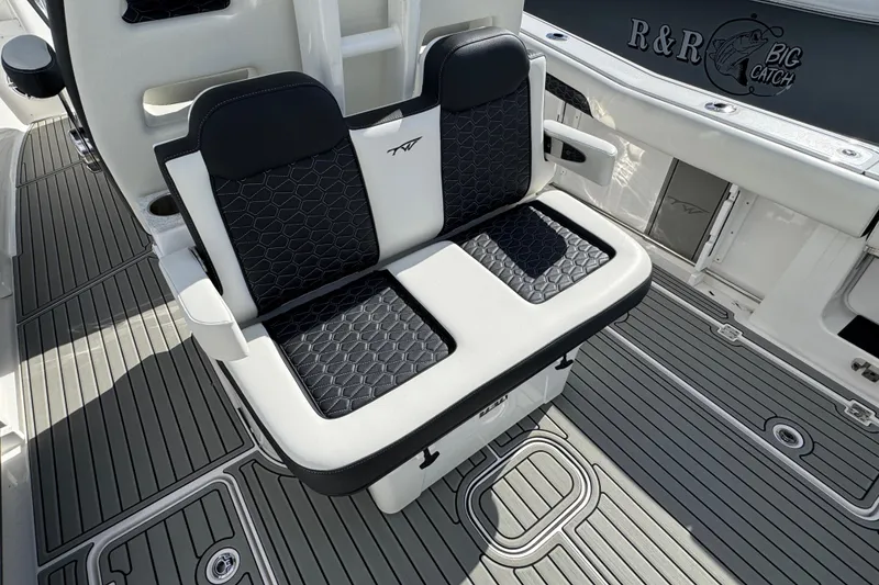 Slide: The Image of 2025 Tidewater 302 CC Adventure boat seating with stylish black and white upholstery. - 22