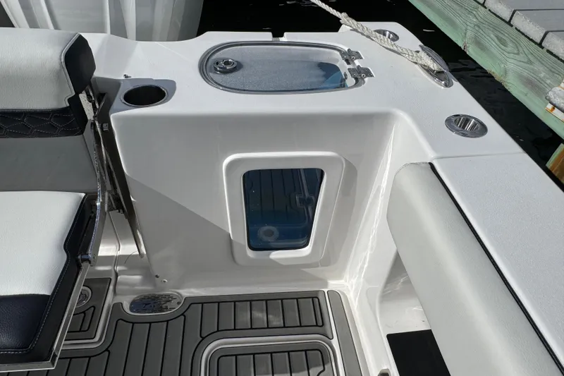Slide: The Image of 2025 Tidewater 302 CC Adventure boat interior with seating and storage compartments. - 26