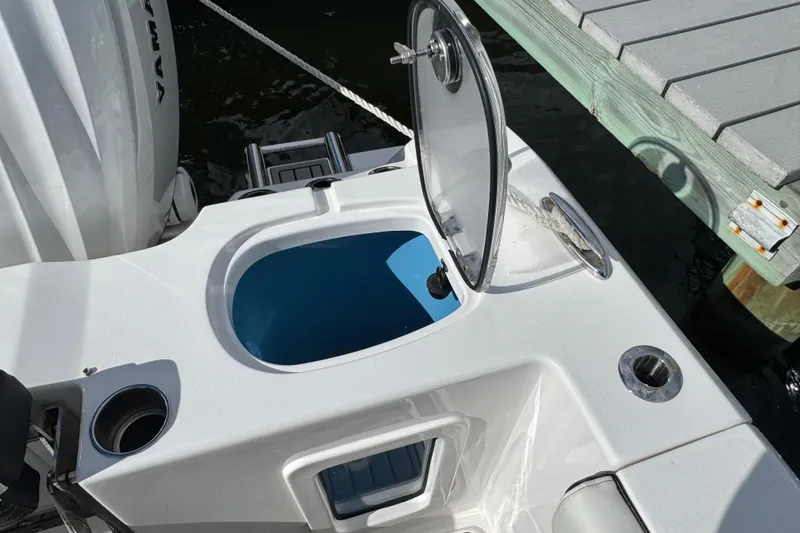 Slide: The Image of 2025 Tidewater 302 CC Adventure boat with open hatch and dockside view. - 27