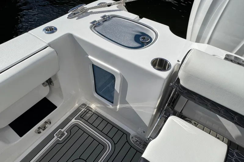 Slide: The Image of 2025 Tidewater 302 CC Adventure boat interior with seating and storage compartments. - 28