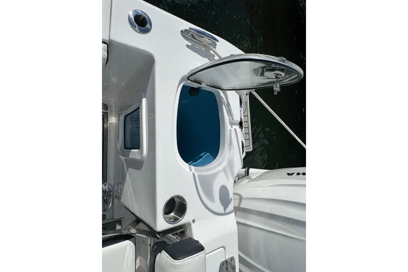 Slide: The Image of 2025 Tidewater 302 CC Adventure boat with open hatch and visible interior compartment. - 29