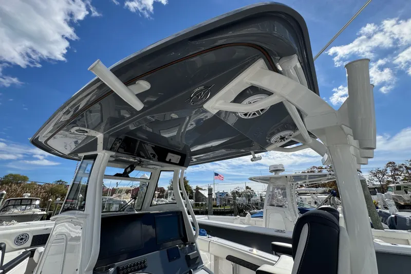 Slide: The Image of 2025 Tidewater 302 CC Adventure boat interior with modern helm and speakers. - 32