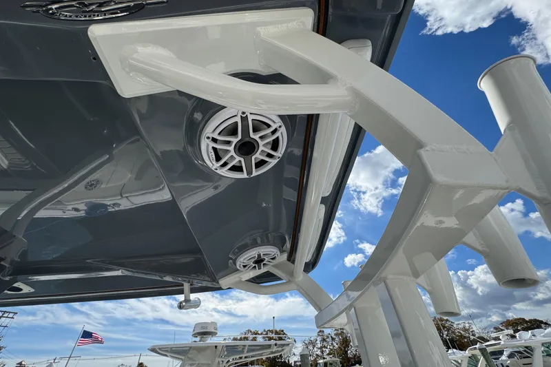 Slide: The Image of 2025 Tidewater 302 CC Adventure boat with speakers, under a clear blue sky. - 35