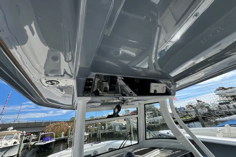 Slide: The Image of 2025 Tidewater 302 CC Adventure boat with advanced navigation equipment, docked at a marina. - 36