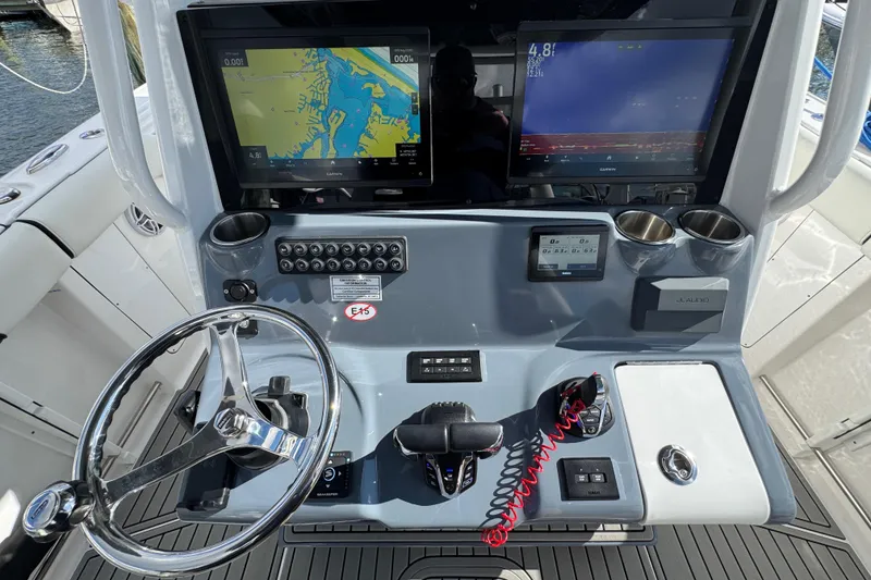 Slide: The Image of 2025 Tidewater 302 CC Adventure boat dashboard with navigation screens and controls. - 41