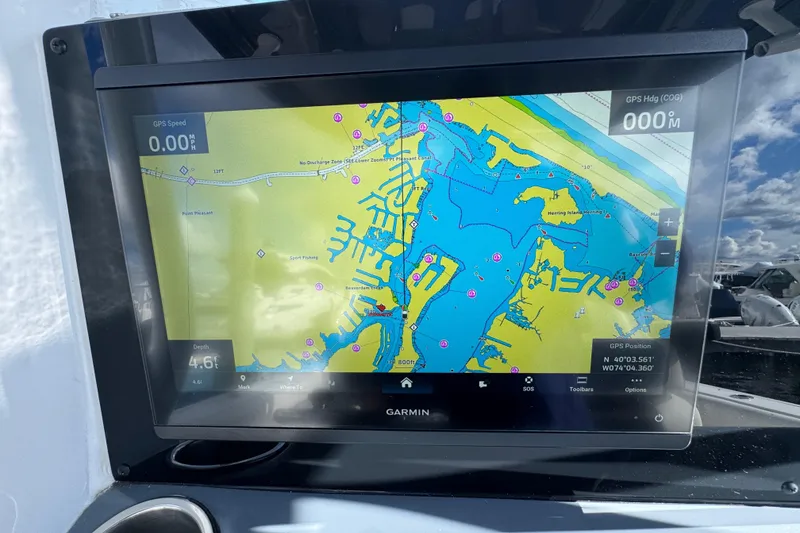 Slide: The Image of Garmin GPS display on 2025 Tidewater 302 CC Adventure boat, showing nautical map and coordinates. - 44