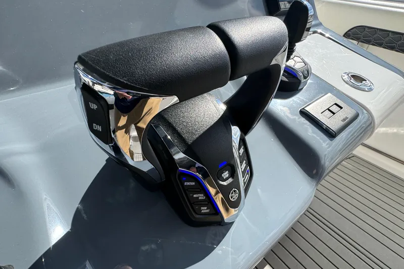 Slide: The Image of Throttle controls on 2025 Tidewater 302 CC Adventure boat dashboard. - 48
