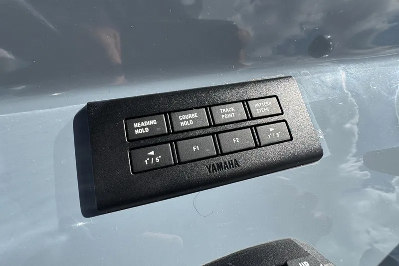 Slide: The Image of Control panel on 2025 Tidewater 302 CC Adventure boat, featuring Yamaha navigation buttons. - 49