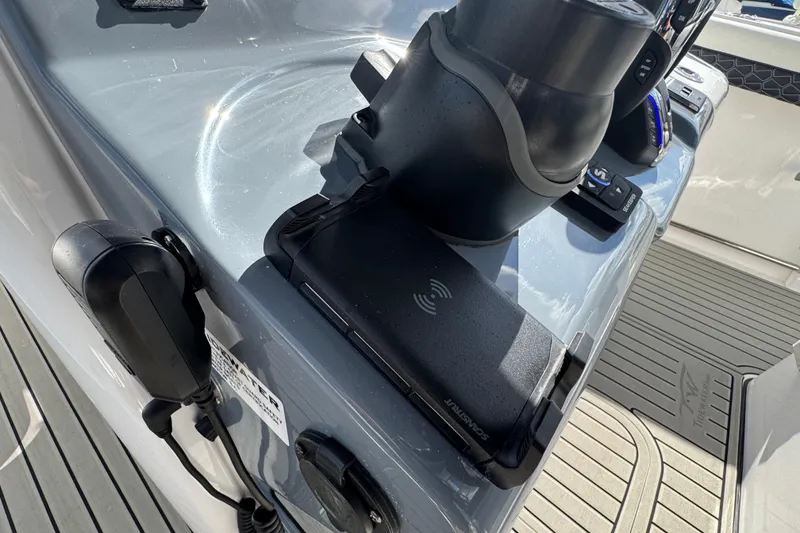 Slide: The Image of Control panel of 2025 Tidewater 302 CC Adventure boat with wireless charging pad. - 51
