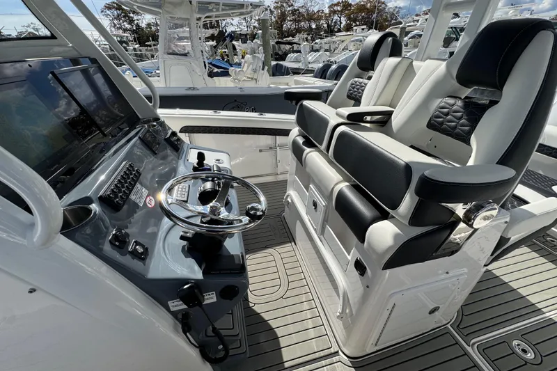 Slide: The Image of 2025 Tidewater 302 CC Adventure boat cockpit with modern steering and luxurious seating. - 52