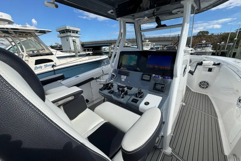 Slide: The Image of 2025 Tidewater 302 CC Adventure boat cockpit with advanced navigation system and sleek design. - 56
