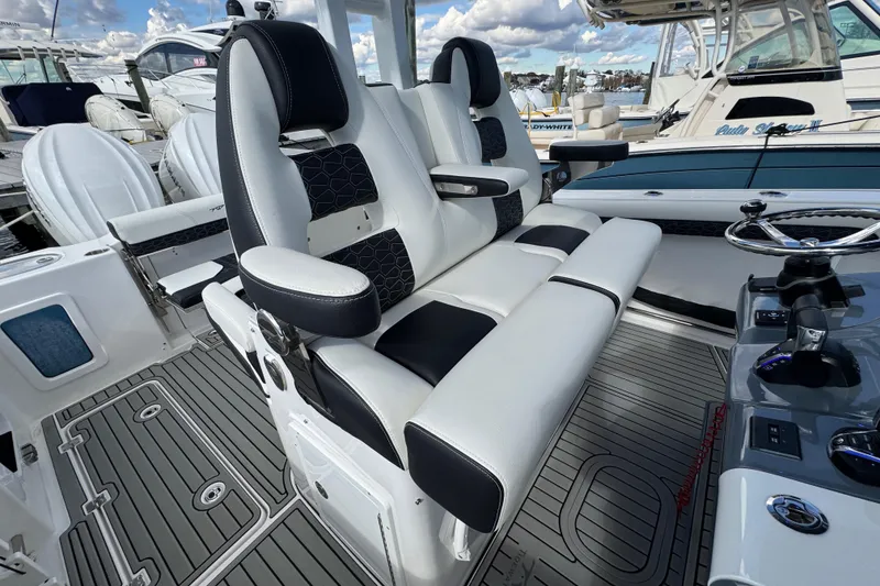 Slide: The Image of 2025 Tidewater 302 CC Adventure boat interior with luxurious seating and modern controls. - 57
