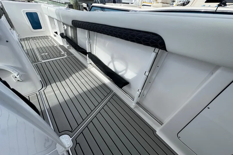 Slide: The Image of 2025 Tidewater 302 CC Adventure boat interior with sleek, modern flooring and storage compartments. - 59