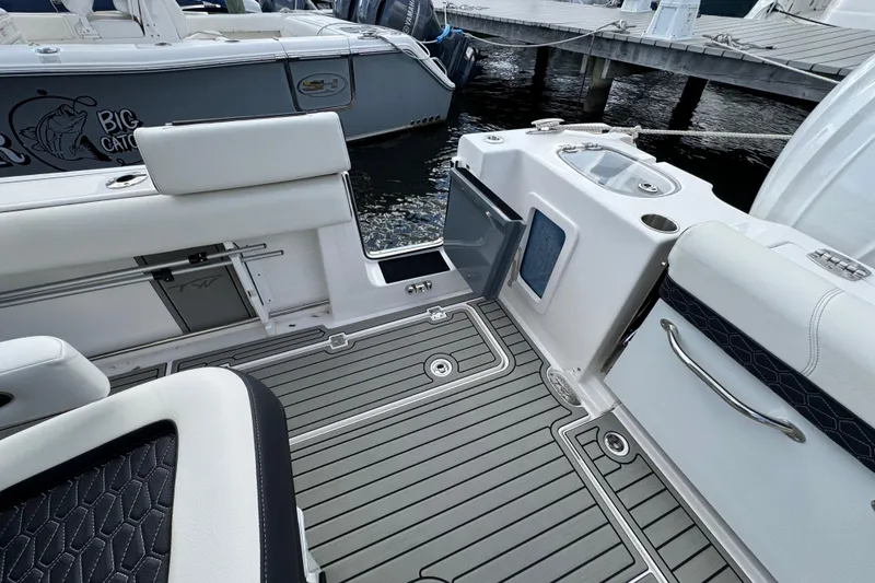 Slide: The Image of 2025 Tidewater 302 CC Adventure boat interior with sleek seating and modern design. - 61