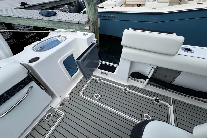 Slide: The Image of 2025 Tidewater 302 CC Adventure boat interior with sleek seating and modern deck design. - 63
