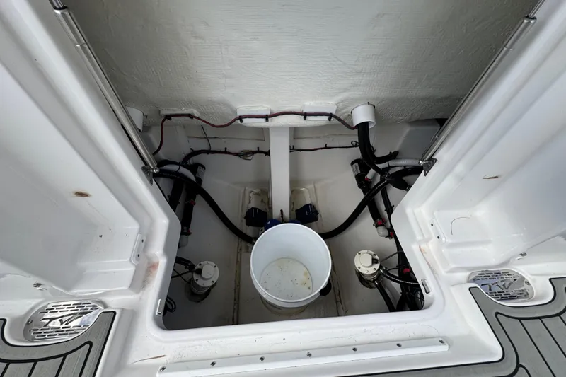 Slide: The Image of 2025 Tidewater 302 CC Adventure boat interior with storage compartment and equipment. - 65