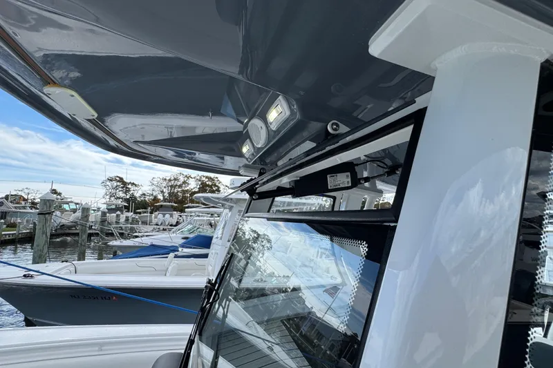 Slide: The Image of 2025 Tidewater 302 CC Adventure boat docked, showcasing sleek design and modern features. - 72