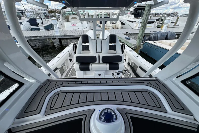 Slide: The Image of 2025 Tidewater 302 CC Adventure boat interior at marina, featuring sleek seating and modern design. - 74
