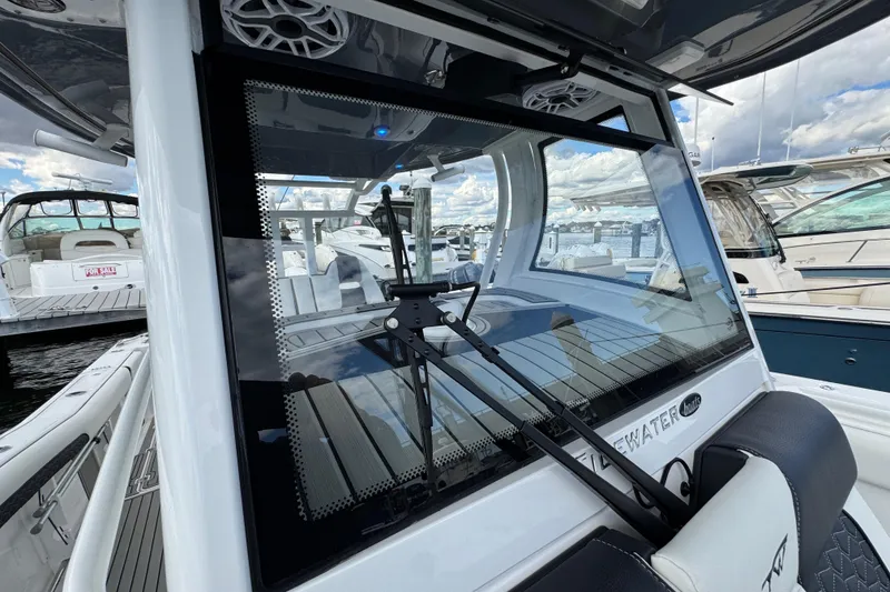 Slide: The Image of 2025 Tidewater 302 CC Adventure boat with sleek design at marina dock. - 75